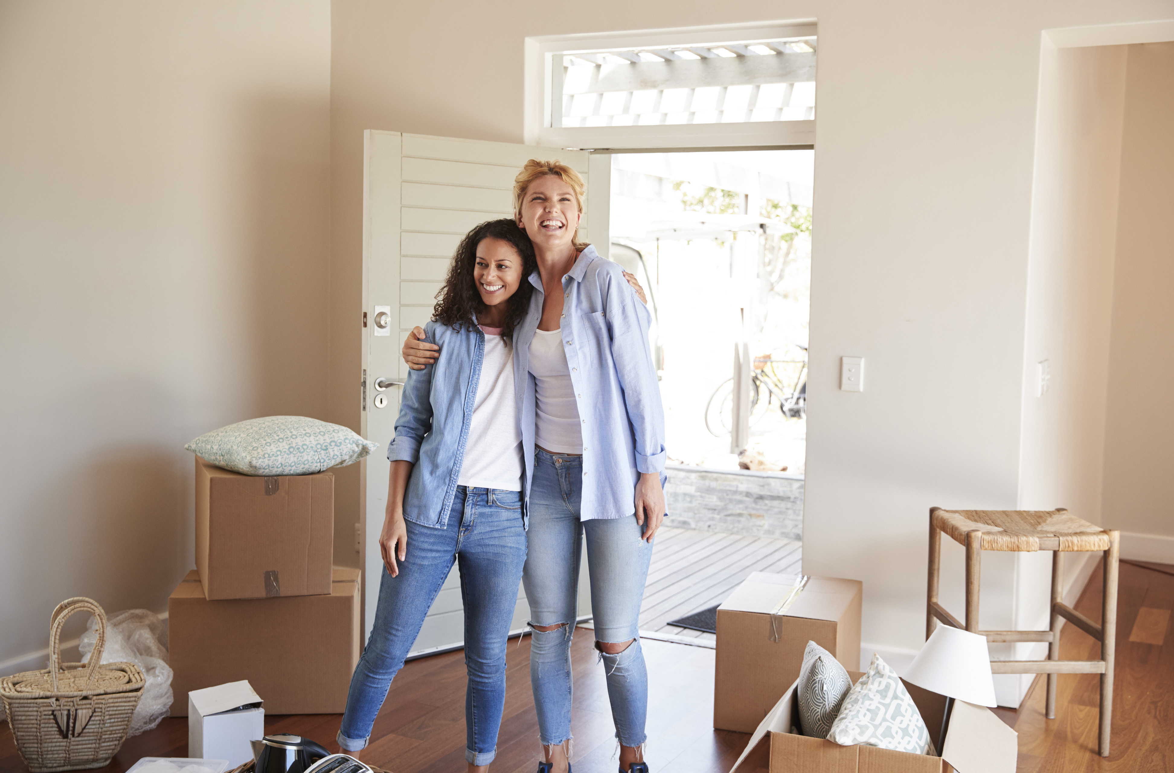 female friends standing in new home